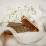 Elegant arrangement of handmade soaps with baby's breath on soft fabric.